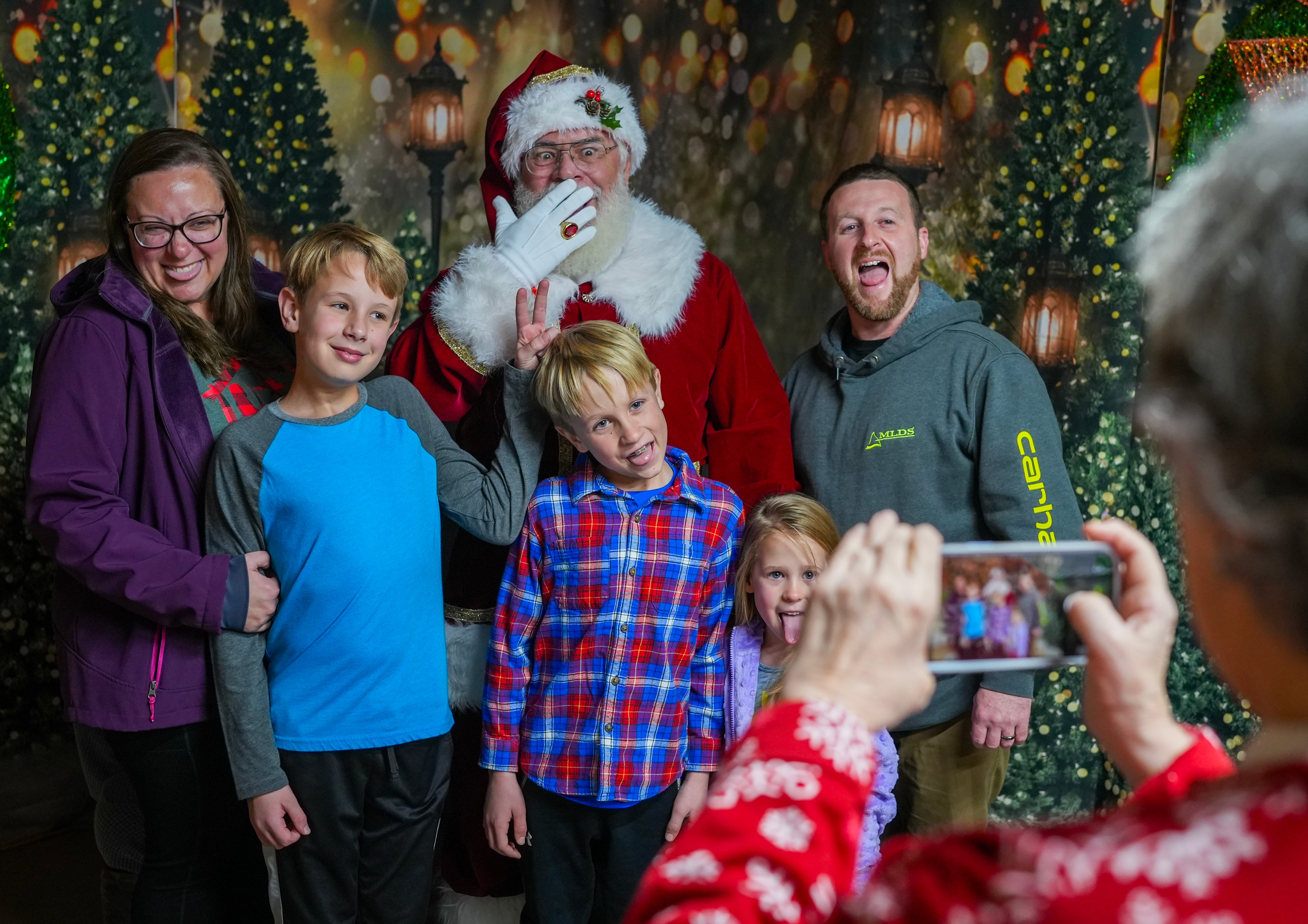 Family waving with Santa at Lights of Joy Christmas Drive-Thru in Branson