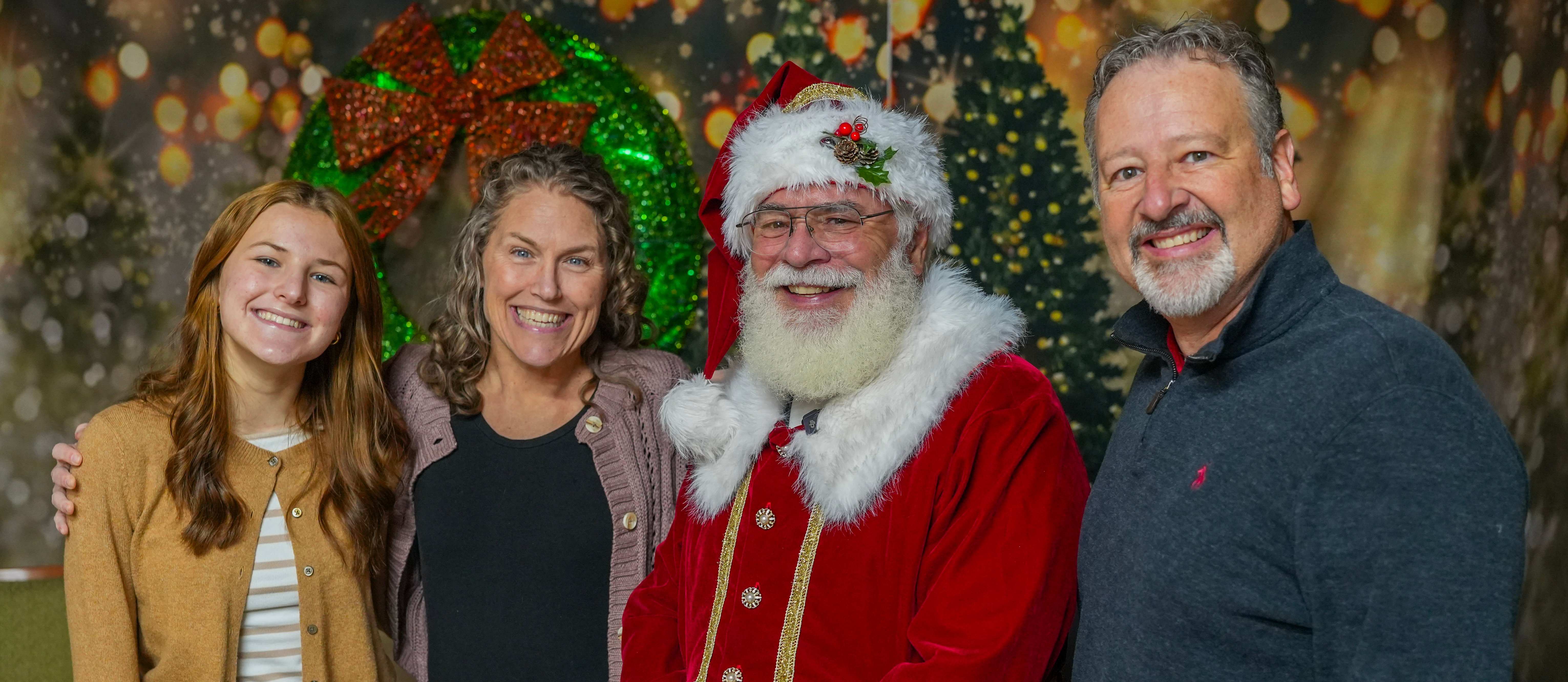 Couple taking free photos with Santa at Lights of Joy Christmas Drive-Thru in Branson, MO