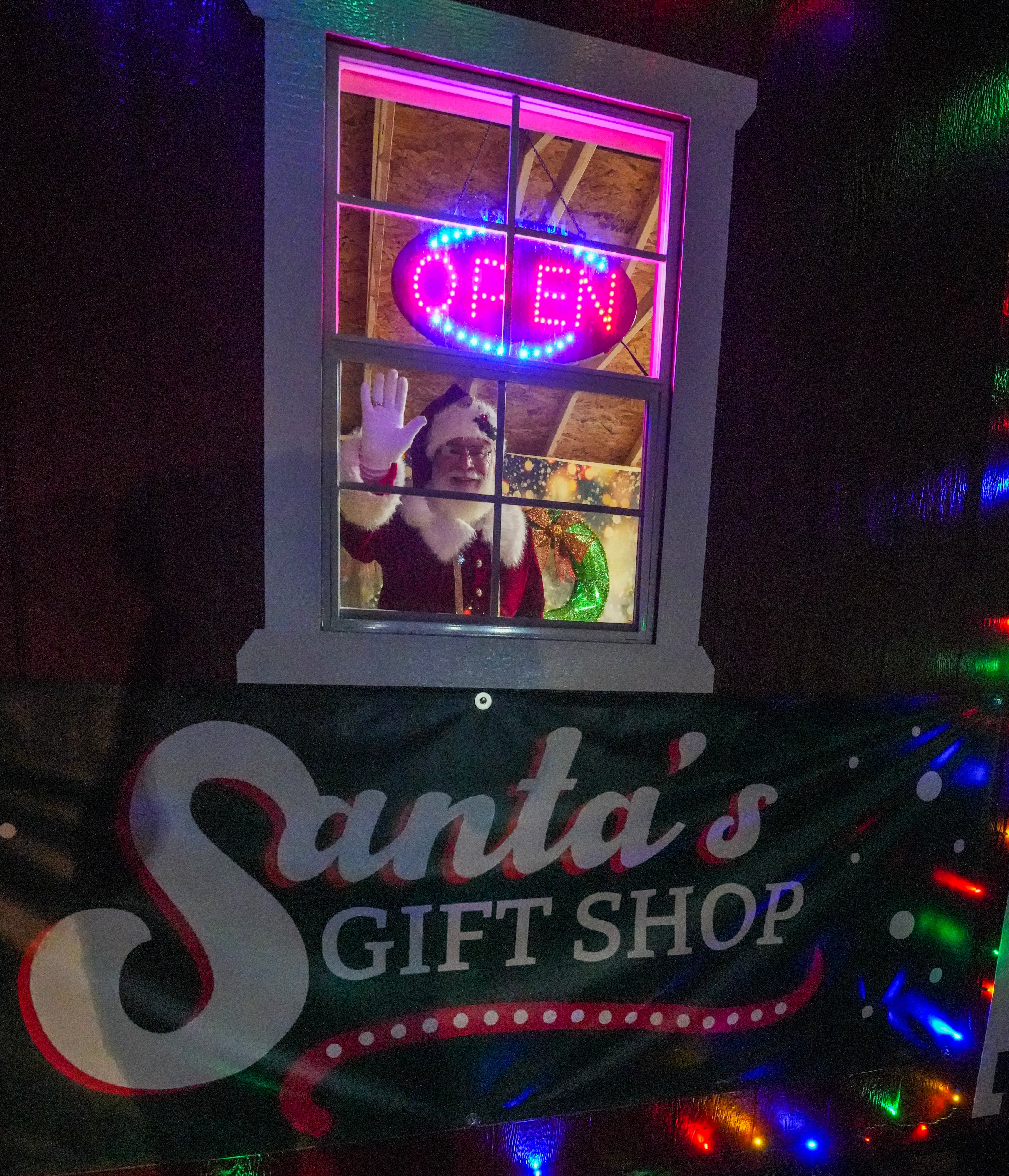 Santa's Gift Shop window glowing at night at Lights of Joy in Branson, Missouri