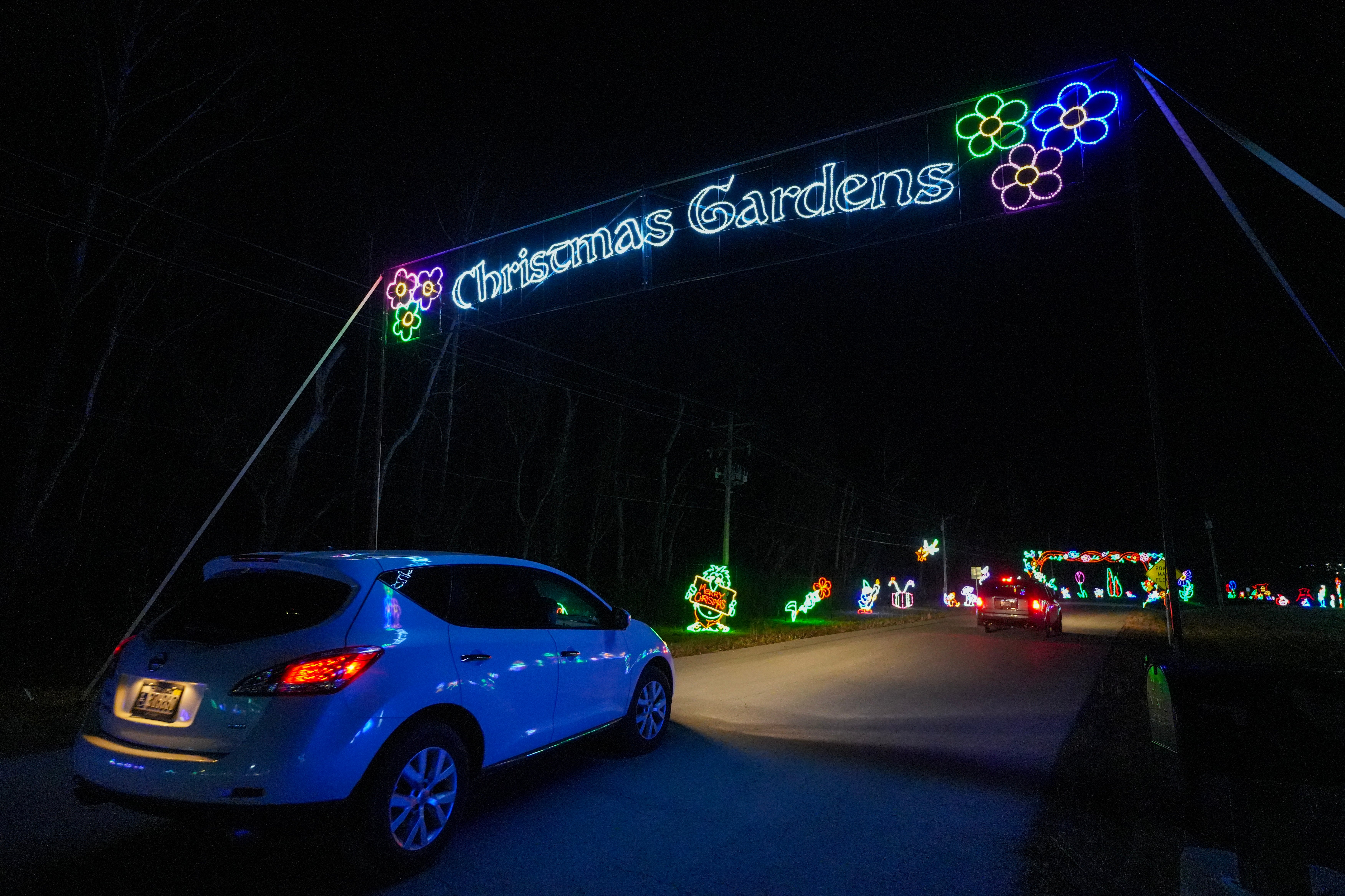 Car passing under the Christmas Gardens arch at Lights of Joy in Branson, Missouri