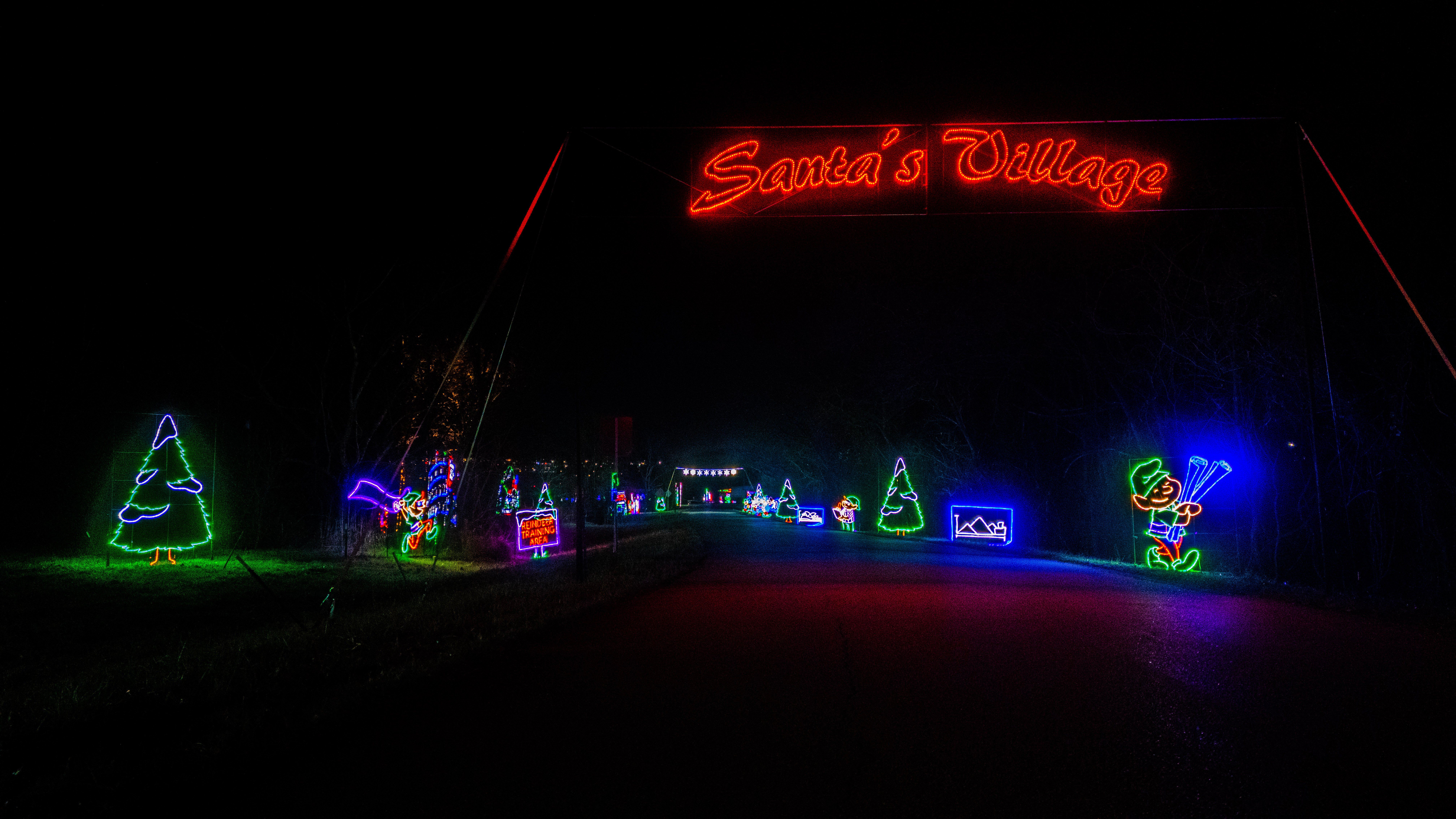 Santa's Village sign glowing at Lights of Joy Christmas Drive-Thru in Branson